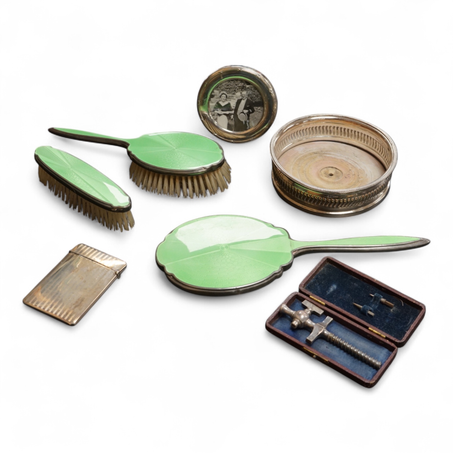 A George V silver rectangular card case by William Henry Sparrow, Birmingham, 1913, 89mm, a modern silver mounted circular photograph frame and five other items including a three piece silver plate and enamel mirror and